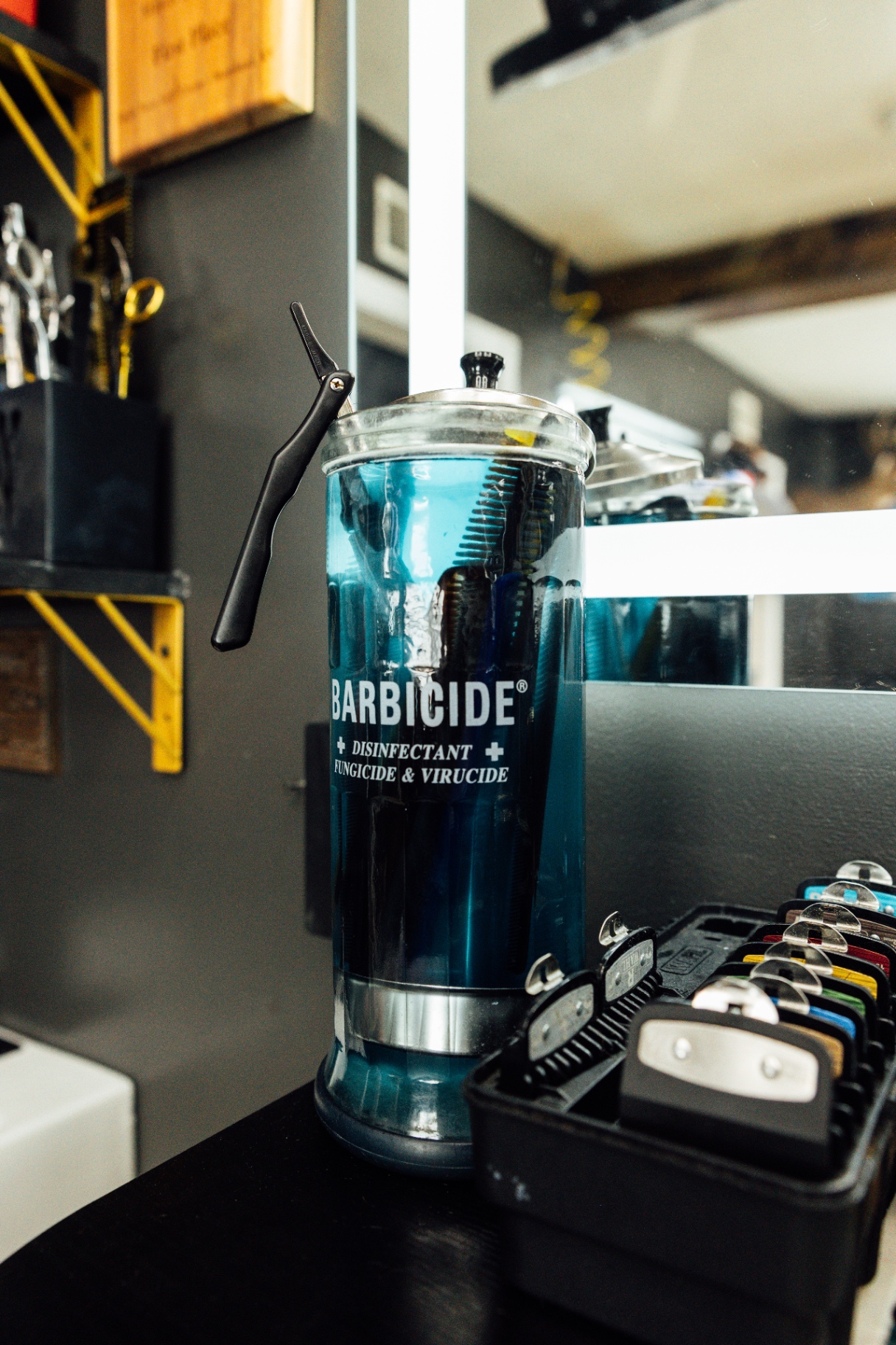 Barbicide jar with a straight razor at the station