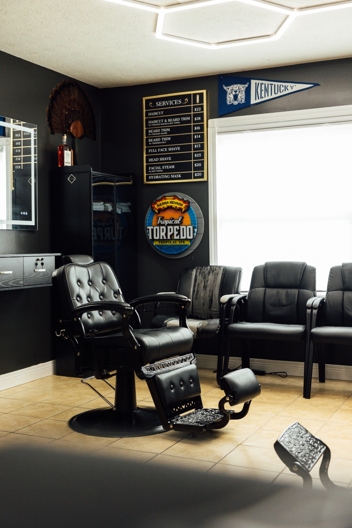 Ace of Fades services menu beside a vintage barber chair